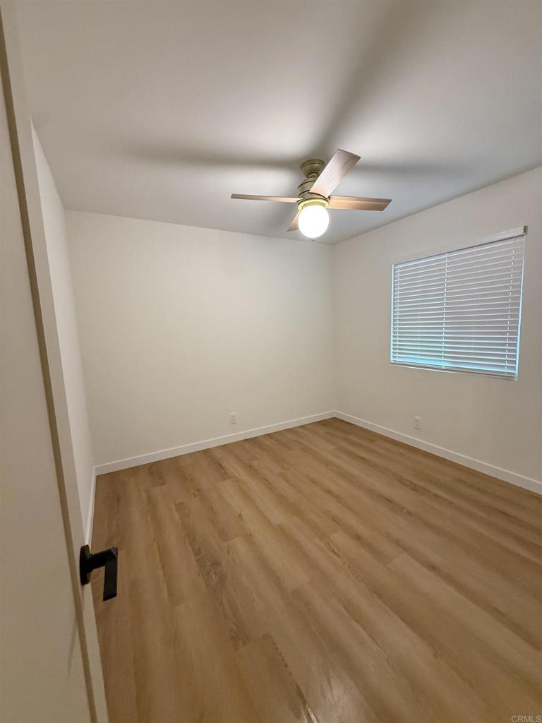 10296 Baroness Avenue San Diego, CA 92126 - Photo 5 of 27 an empty room with a fan & a window