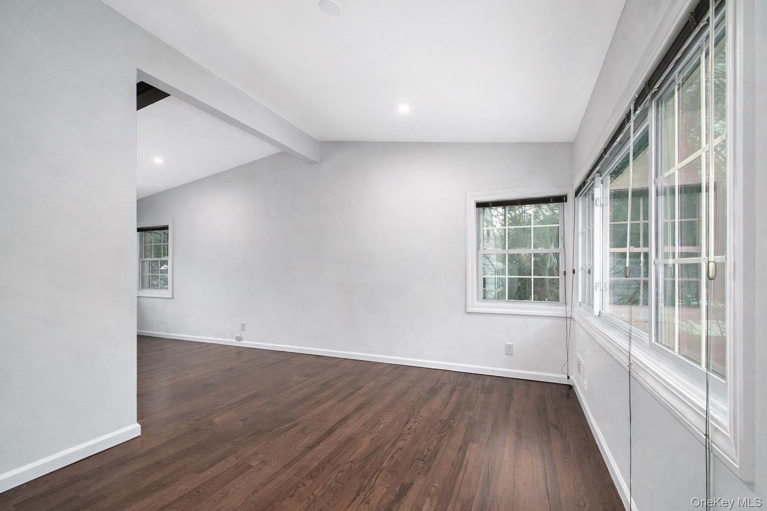 415 Pinebrook Boulevard New Rochelle, NY 10804 - Photo 19 of 20 an empty room with wooden floor and windows
