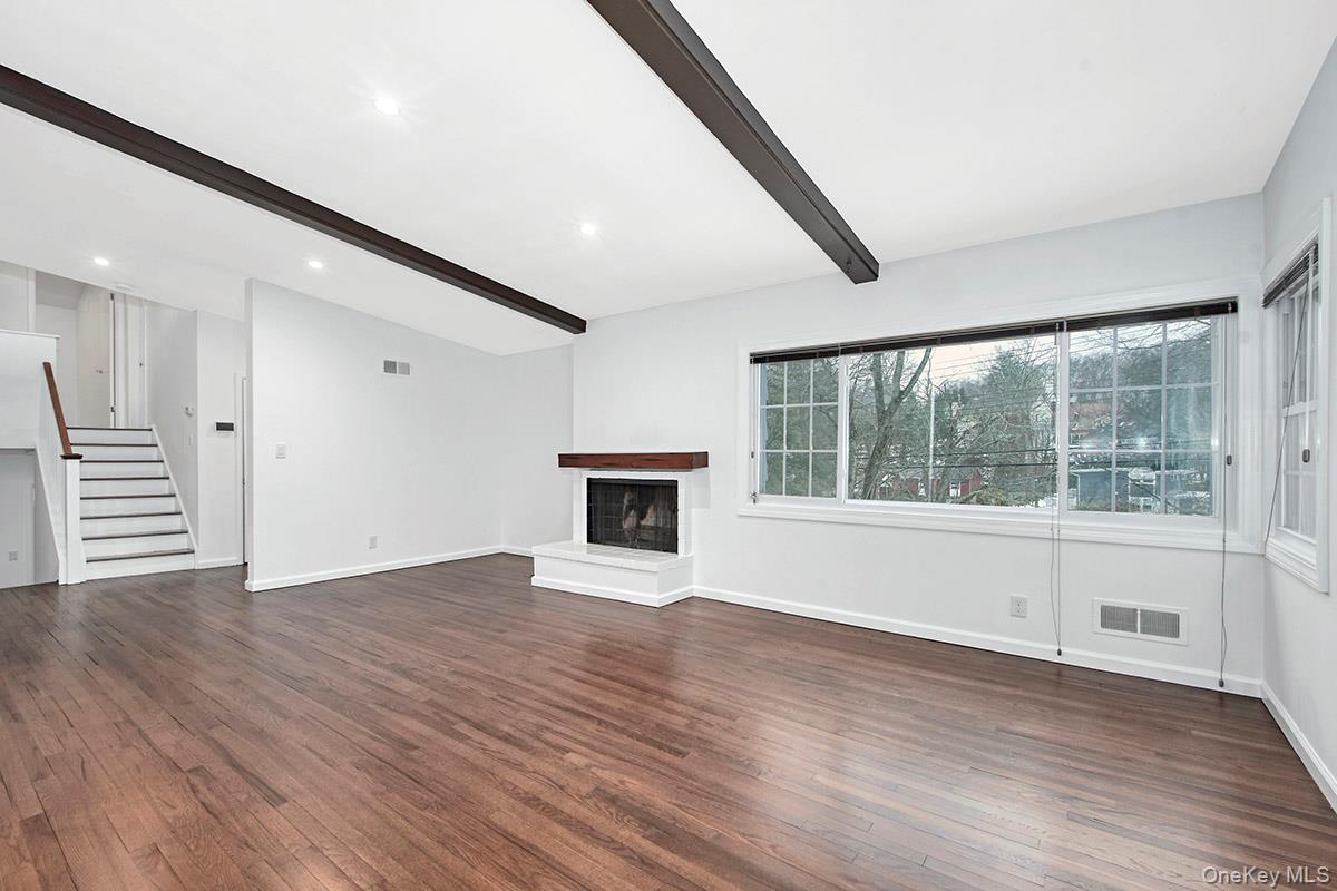415 Pinebrook Boulevard New Rochelle, NY 10804 - Photo 4 of 20 a view of an empty room with a window and wooden floor