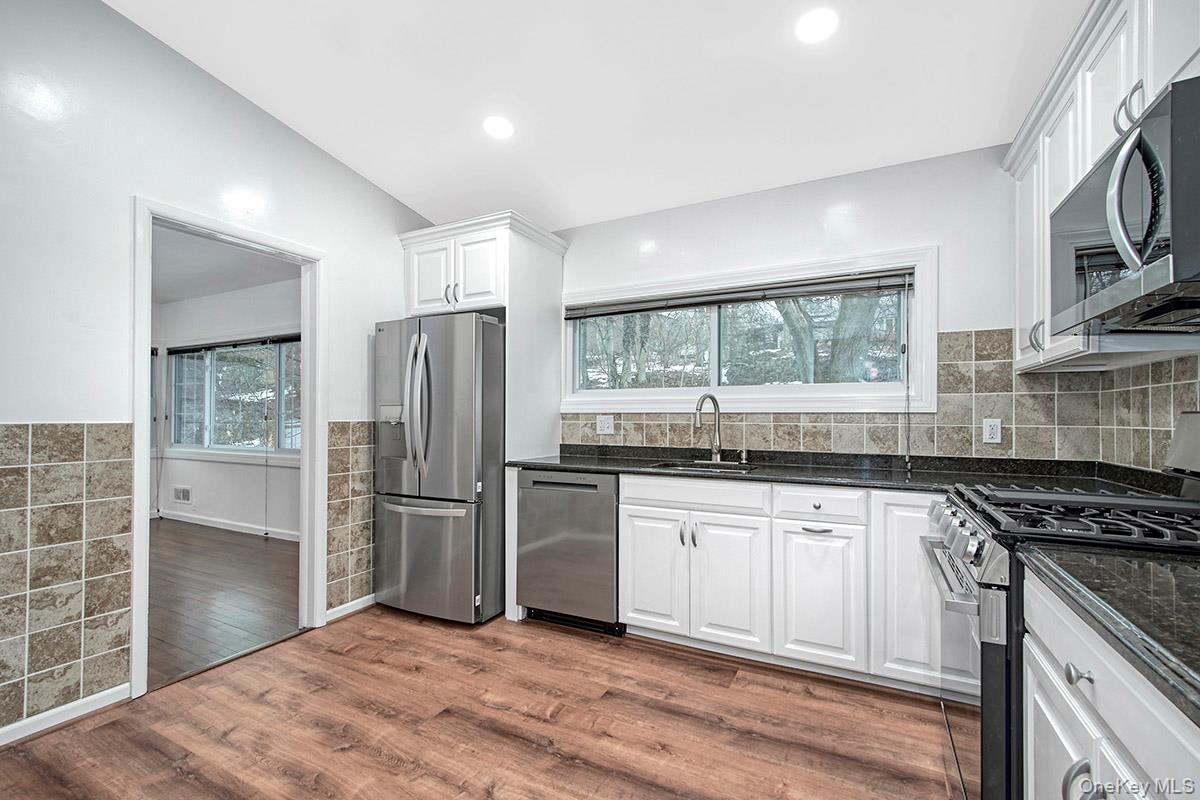 415 Pinebrook Boulevard New Rochelle, NY 10804 - Photo 9 of 20 a kitchen with stainless steel appliances granite countertop a refrigerator and a sink