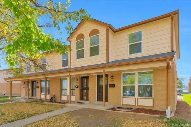 a kitchen with a sink a refrigerator and windows
