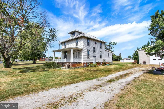 a big house with a big yard and large trees