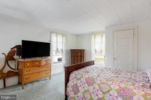 a bedroom with a bed and a flat screen tv in it