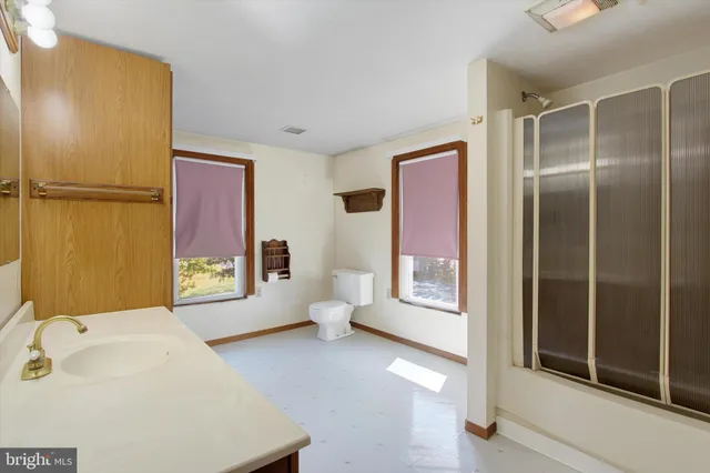 a spacious bathroom with a bathtub and a shower