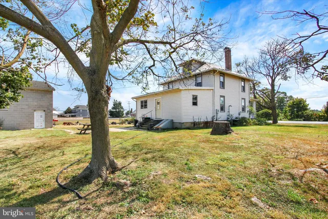 a view of a house with a yard covered with snow