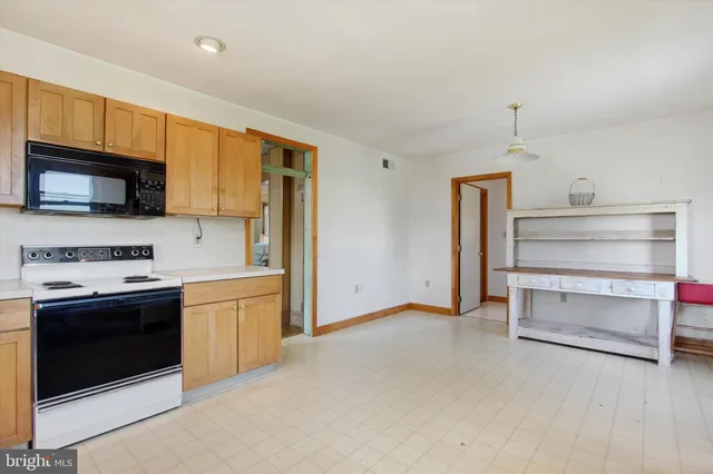 a kitchen with stainless steel appliances a stove microwave and a refrigerator