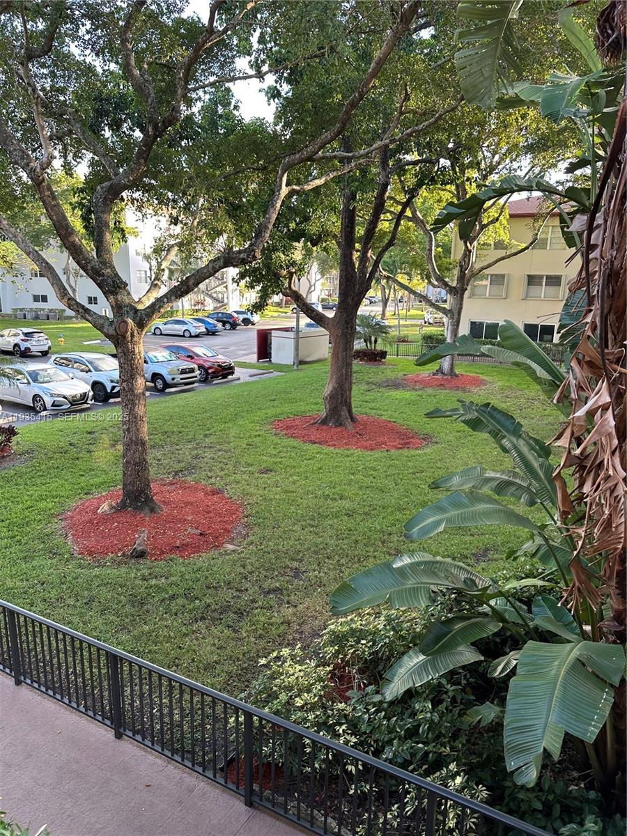 200 Southwest 132nd Way, Unit 310L Pembroke Pines, FL 33027 - Photo 2 of 4 a view of a garden with a tree