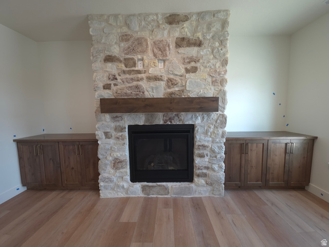 1267 West 2350 South Perry, UT 84302 - Photo 3 of 20 Stone-clad fireplace featuring a dark wood mantel and a black firebox