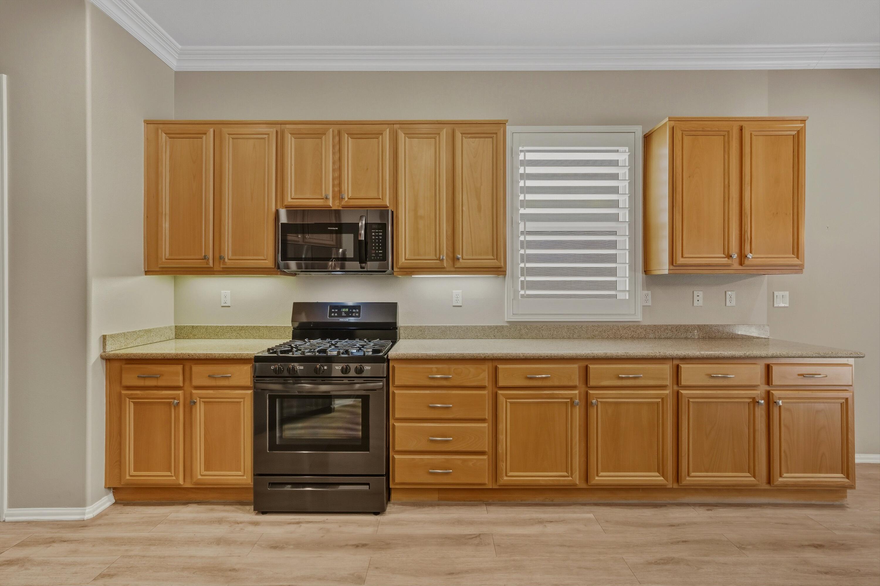 49465 Lewis Road Indio, CA 92201 - Photo 12 of 31 a kitchen with a stove and a sink