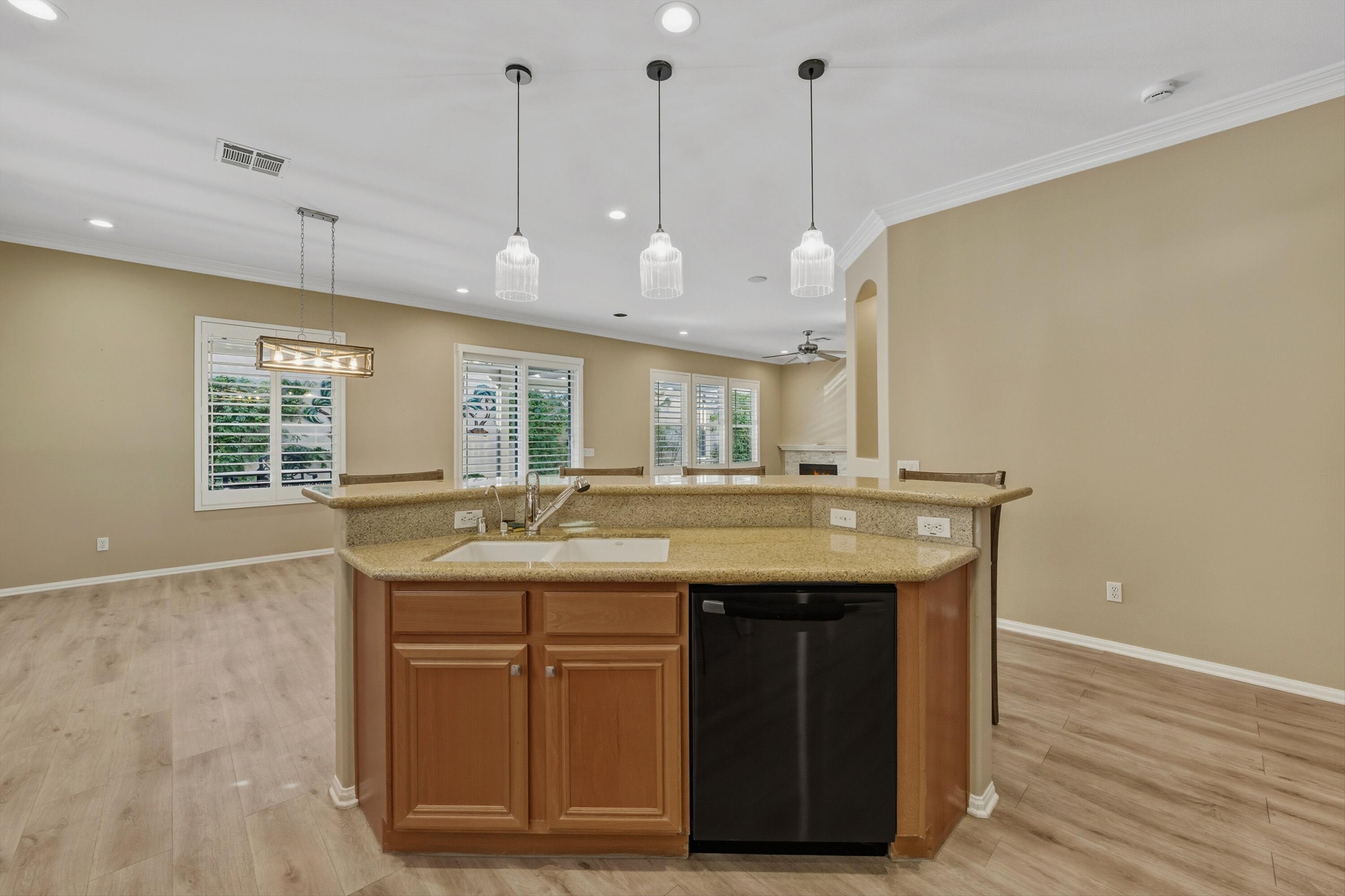 49465 Lewis Road Indio, CA 92201 - Photo 13 of 31 a view of a kitchen with a sink and chandelier