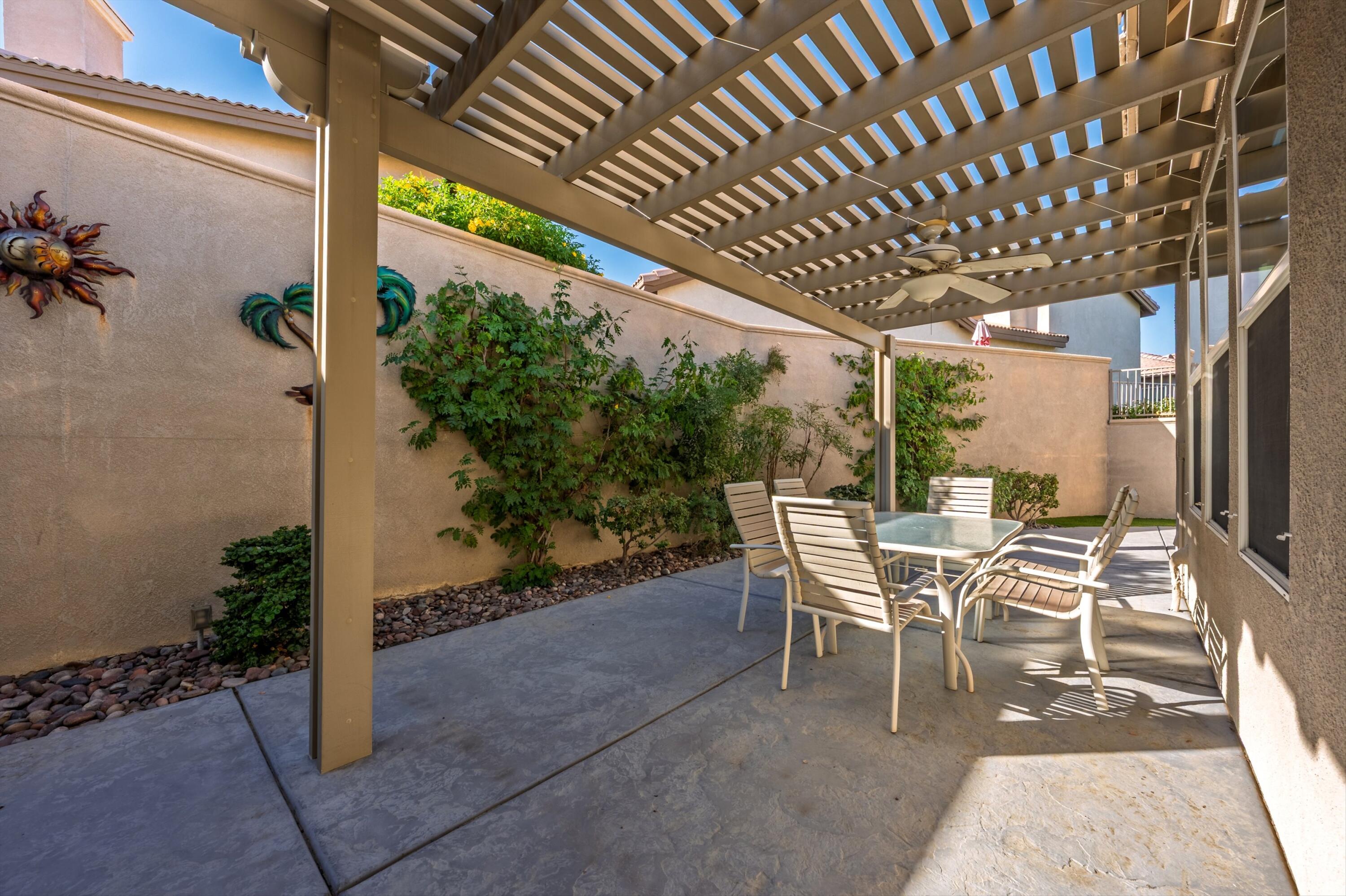 49465 Lewis Road Indio, CA 92201 - Photo 17 of 31 a view of a patio with table and chairs and potted plants
