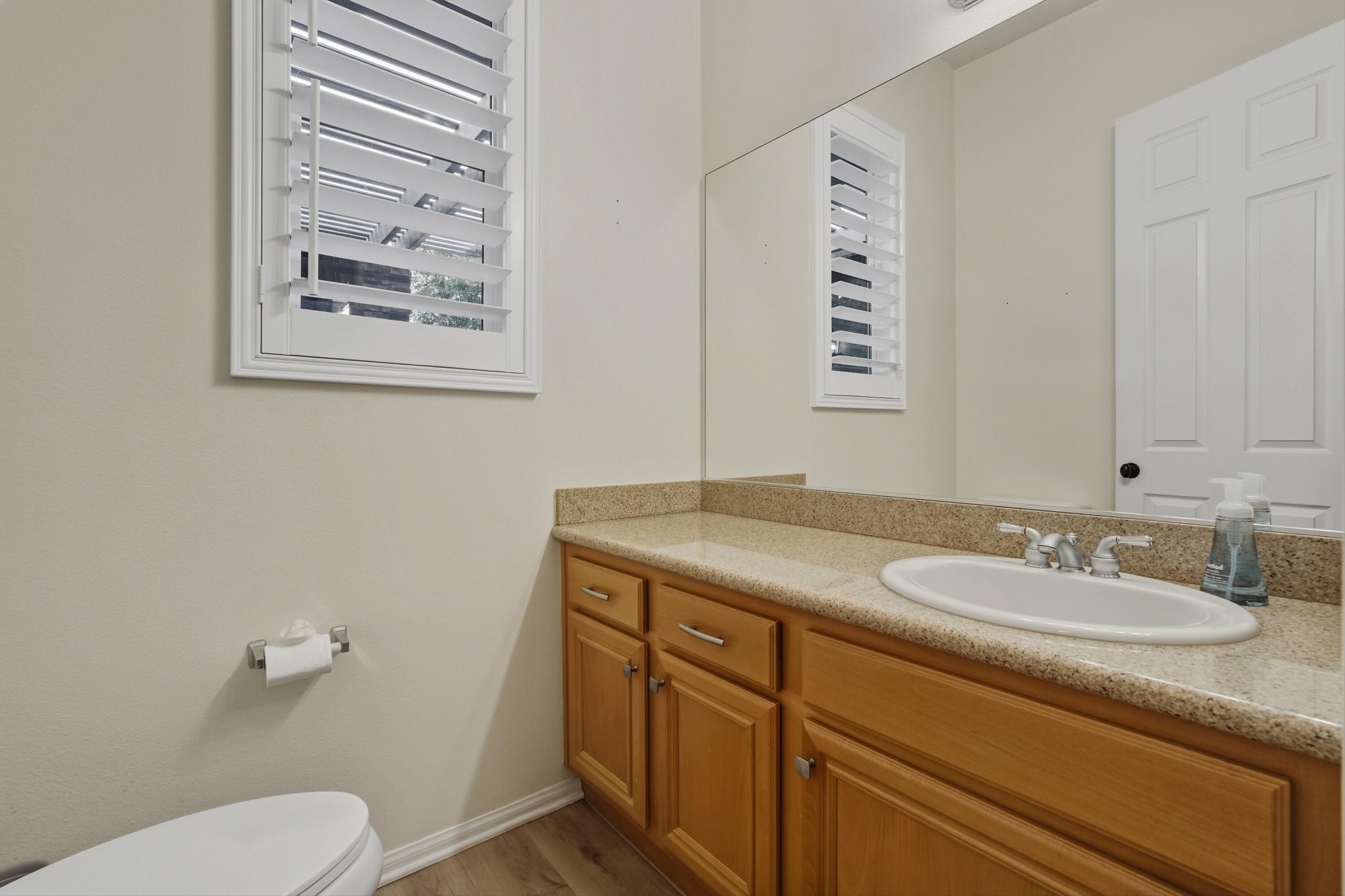 49465 Lewis Road Indio, CA 92201 - Photo 19 of 31 a bathroom with a granite countertop sink mirror and toilet