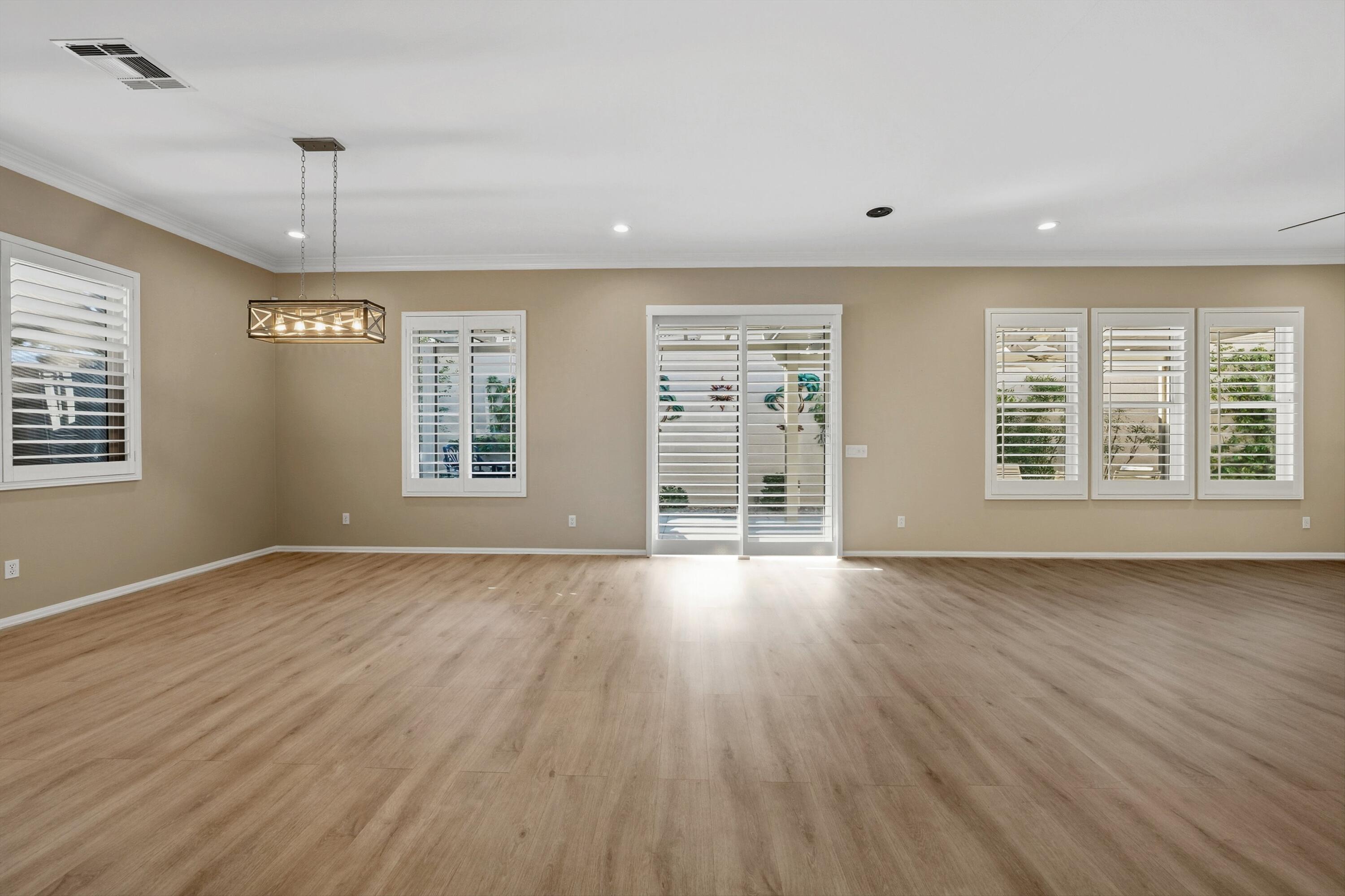 49465 Lewis Road Indio, CA 92201 - Photo 7 of 31 a view of an empty room with a window and wooden floor