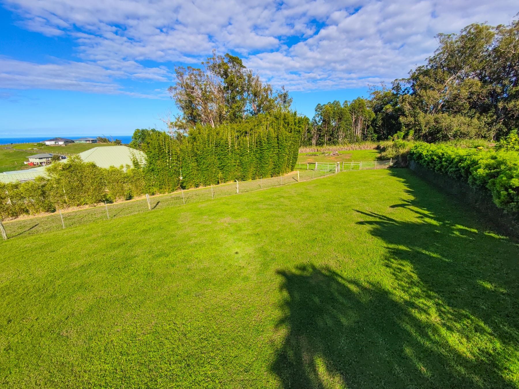 57 Awalau Road, Unit A Haiku, HI 96708 - Photo 7 of 22 a view of an ocean and a yard
