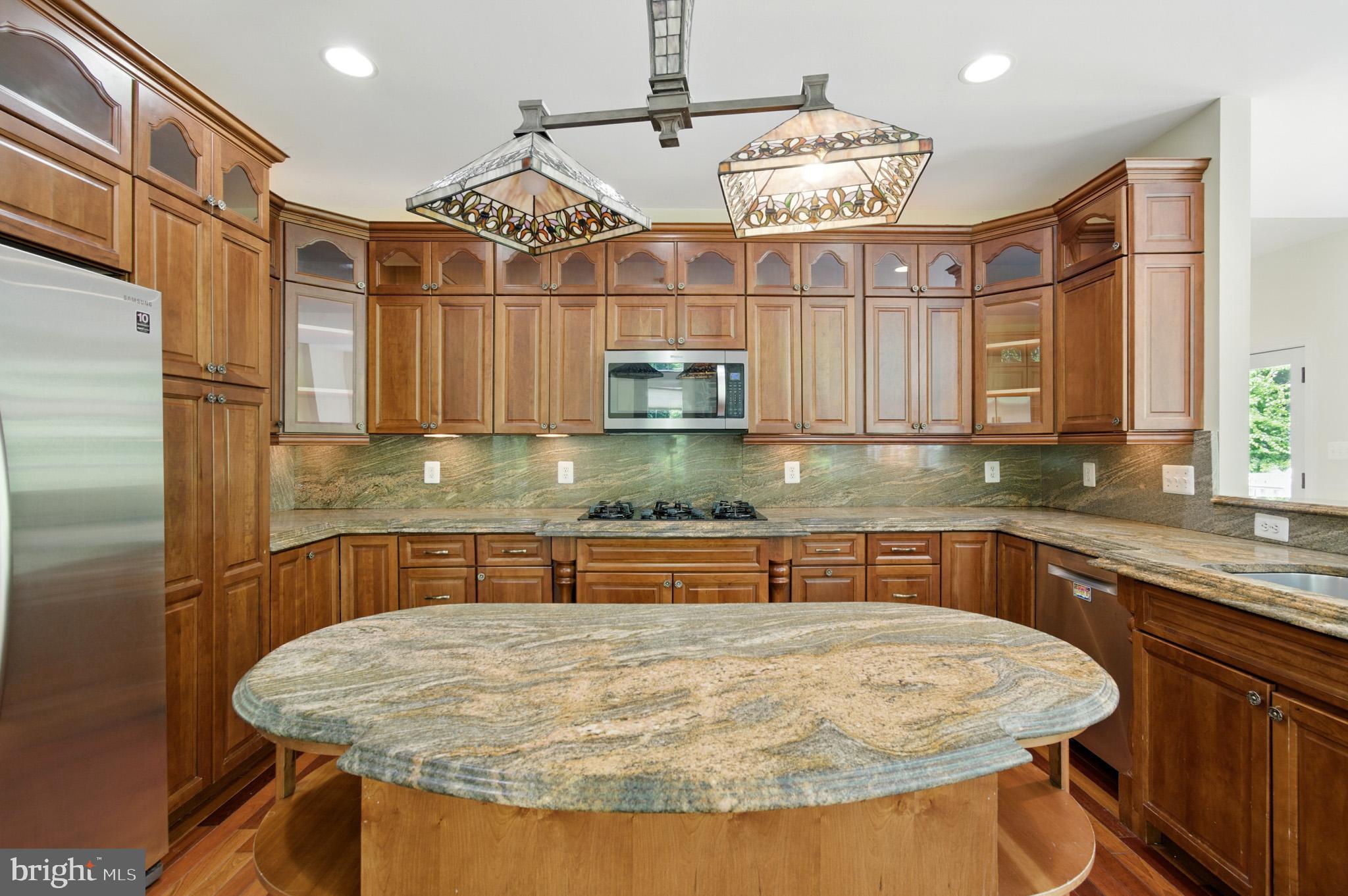 1002 Covington Way Annapolis, MD 21401 - Photo 27 of 78 a kitchen with stainless steel appliances granite countertop a sink a oven and wooden cabinets