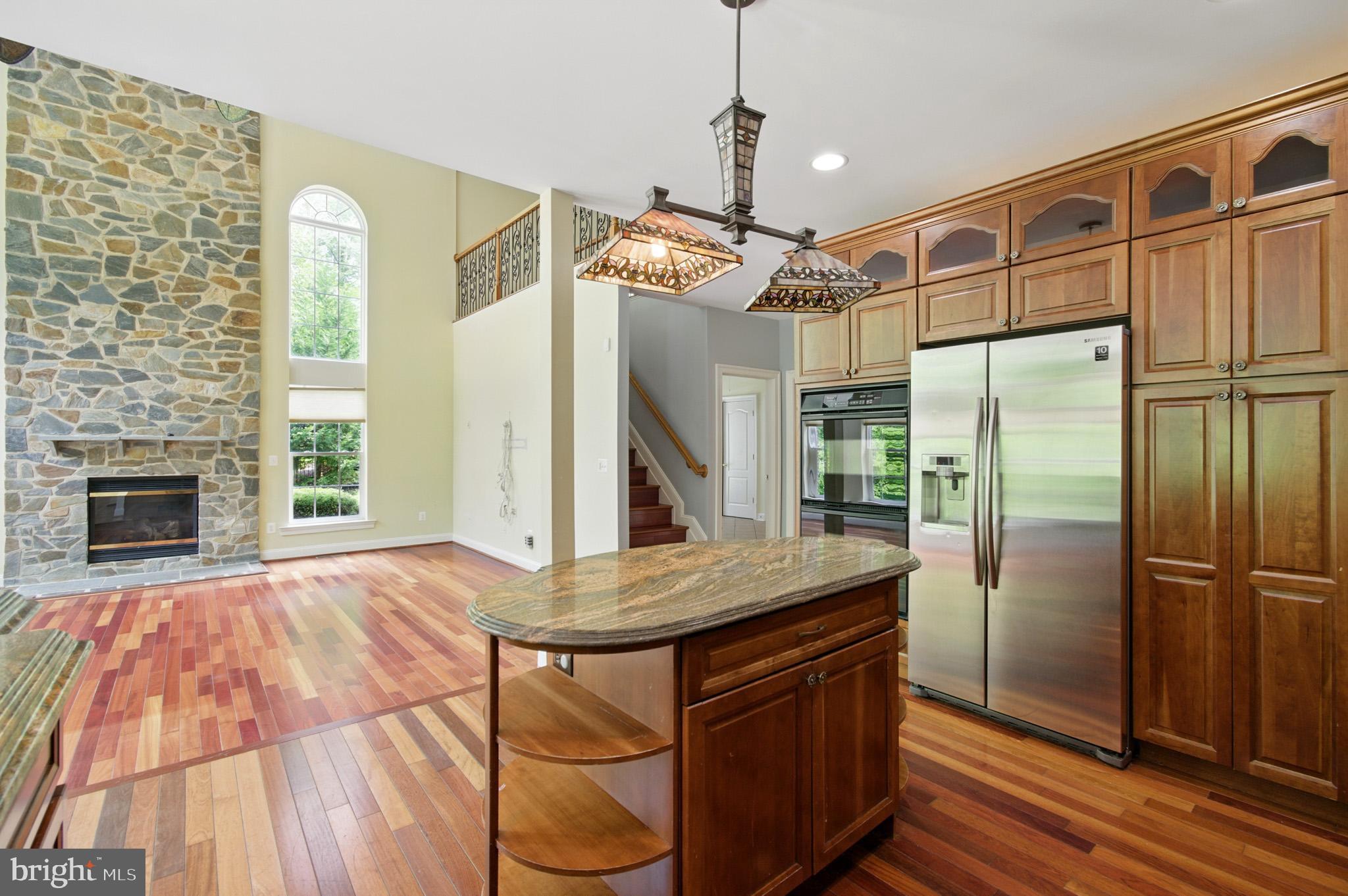 1002 Covington Way Annapolis, MD 21401 - Photo 29 of 78 a kitchen with stainless steel appliances granite countertop a refrigerator a oven and a fireplace with wooden floor
