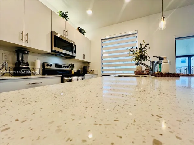 a view of kitchen with sink and natural light
