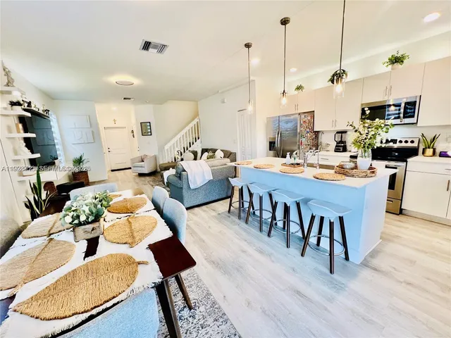 a large kitchen with a table and chairs