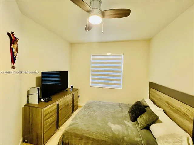 a bedroom with a bed and flat screen tv