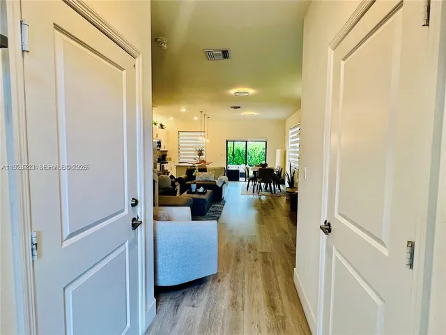a view of living room with furniture and wooden floor