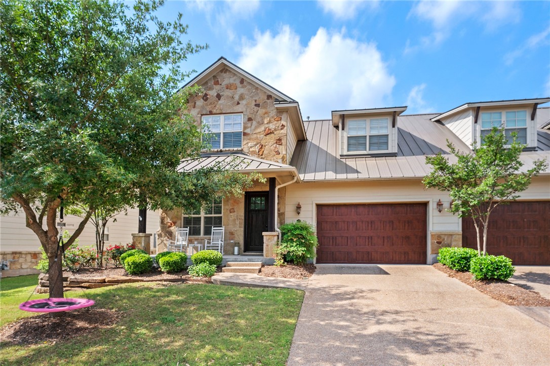 3400 Heisman Circle, Unit 3A Bryan, TX 77807 - Photo 1 of 1 a front view of a house with a yard and garage