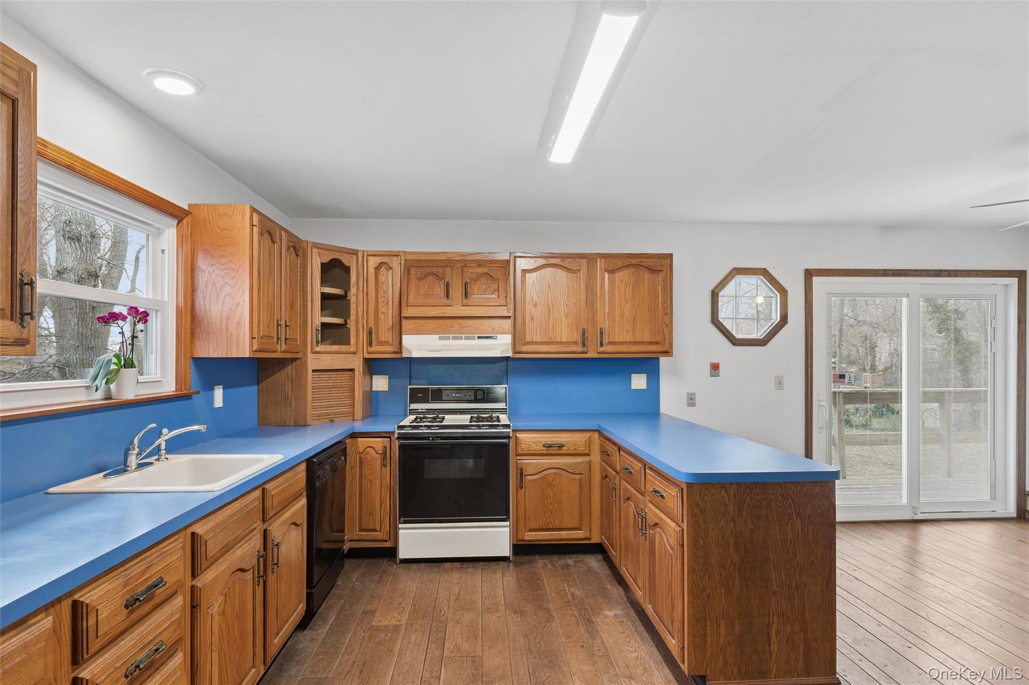 49 Overhill Road Wading River, NY 11792 - Photo 7 of 27 a kitchen with stainless steel appliances granite countertop a stove a sink and a refrigerator