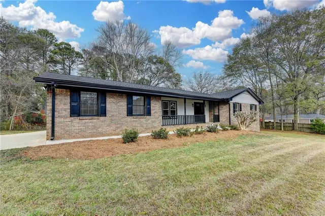 a front view of house with yard seating and green space