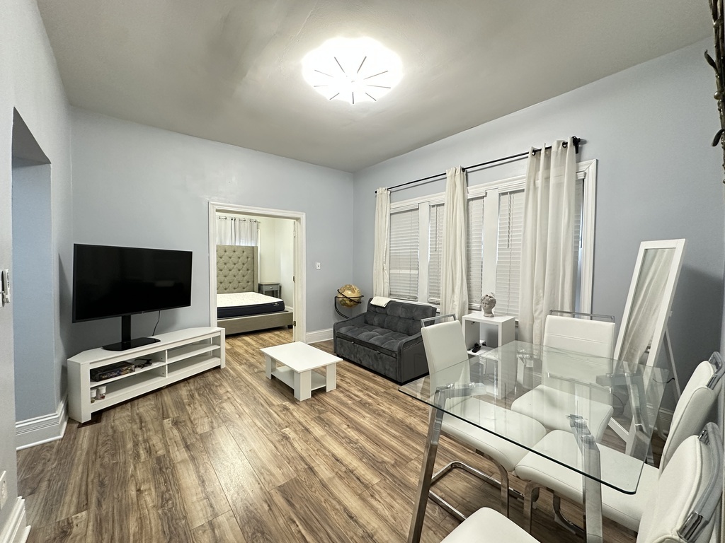 720 North Elizabeth Street, Unit 1 Chicago, IL 60642 - Photo 12 of 20 a living room with furniture and a flat screen tv