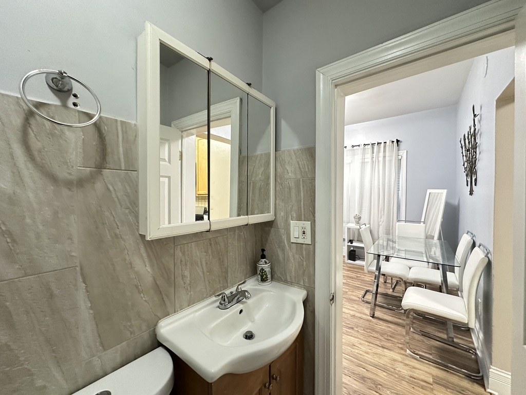 720 North Elizabeth Street, Unit 1 Chicago, IL 60642 - Photo 19 of 20 a bathroom with a sink a toilet and a mirror