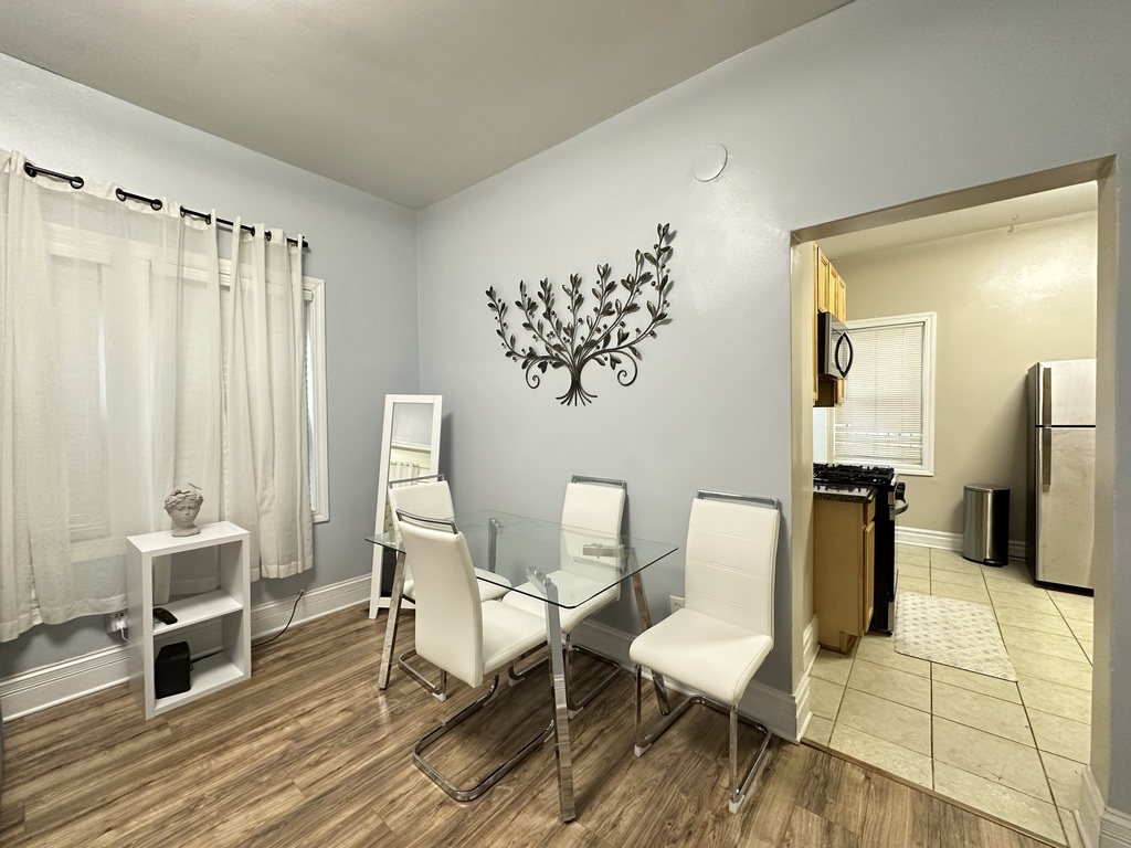 720 North Elizabeth Street, Unit 1 Chicago, IL 60642 - Photo 8 of 20 a living room with furniture a table and chair with wooden floor