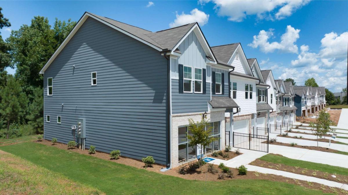 a backyard of a house with table and chairs