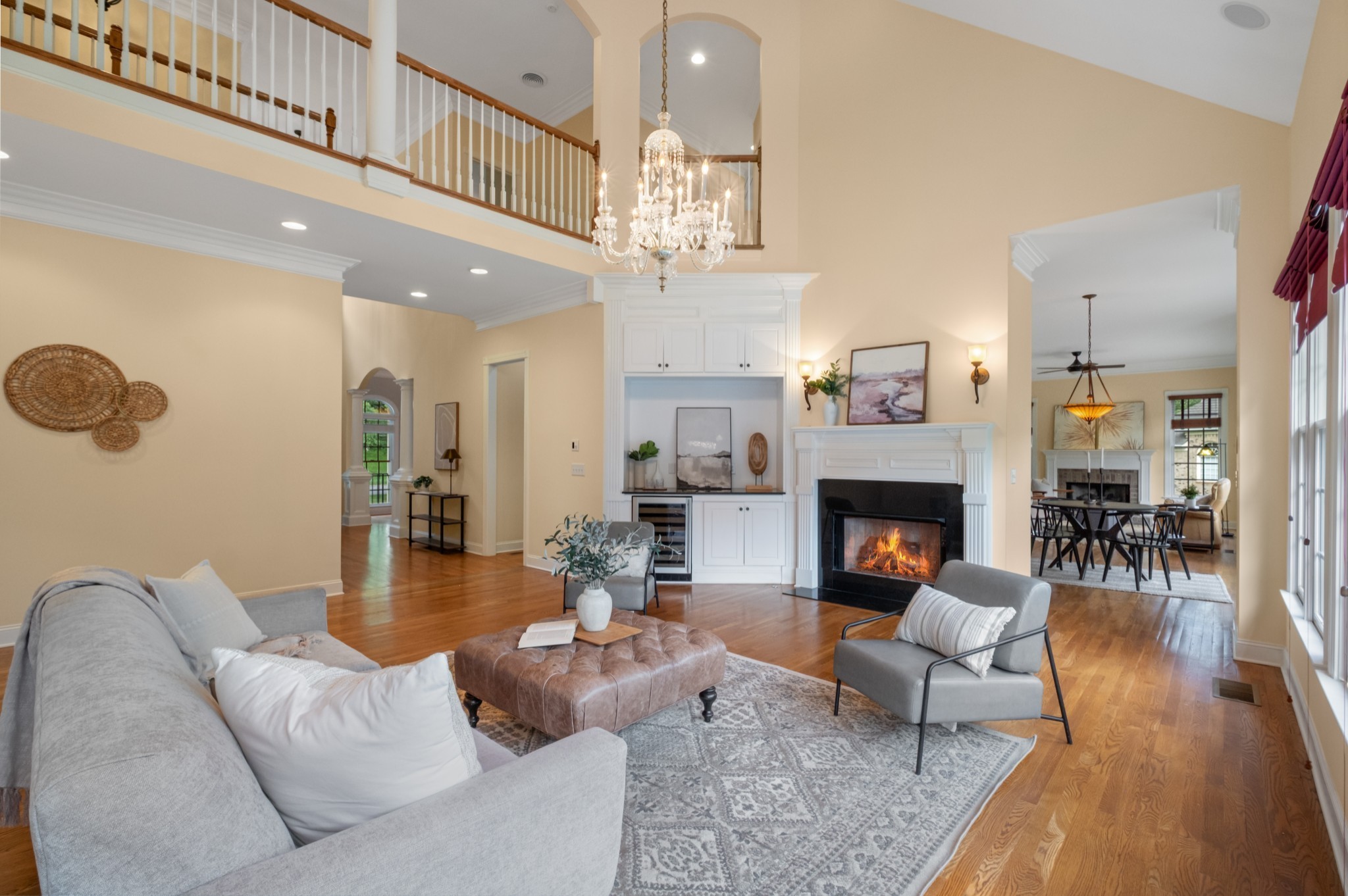424 Sandcastle Road Franklin, TN 37069 - Photo 26 of 62 a living room with furniture a fireplace and a chandelier