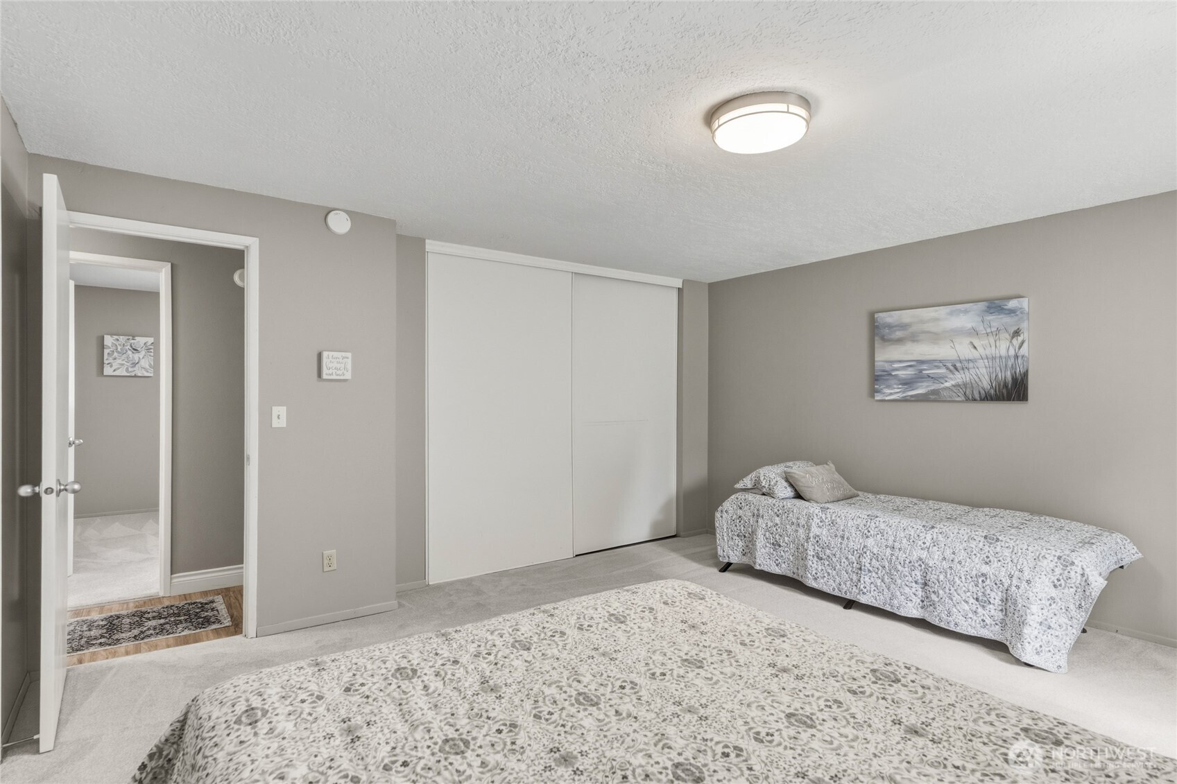 369 East Birnie Slough Road Cathlamet, WA 98612 - Photo 17 of 31 a bedroom with a bed and a painting on the wall
