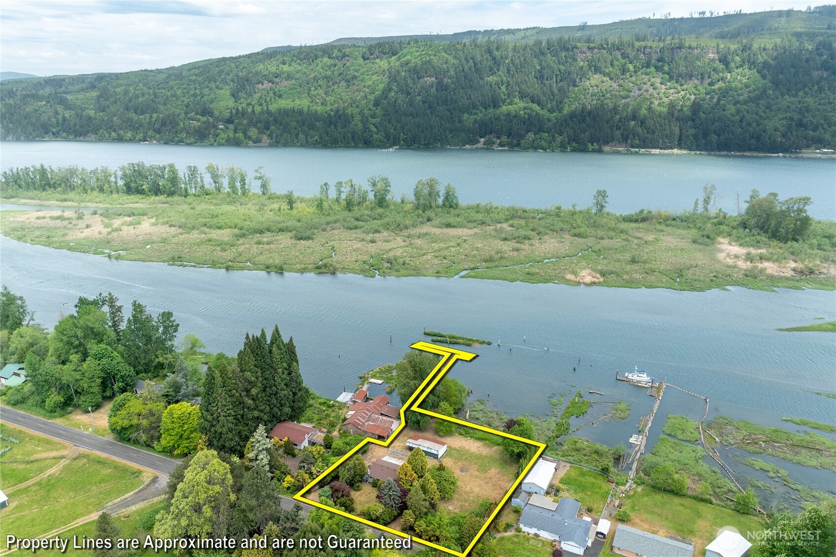 369 East Birnie Slough Road Cathlamet, WA 98612 - Photo 3 of 31 a view of a lake with a yard