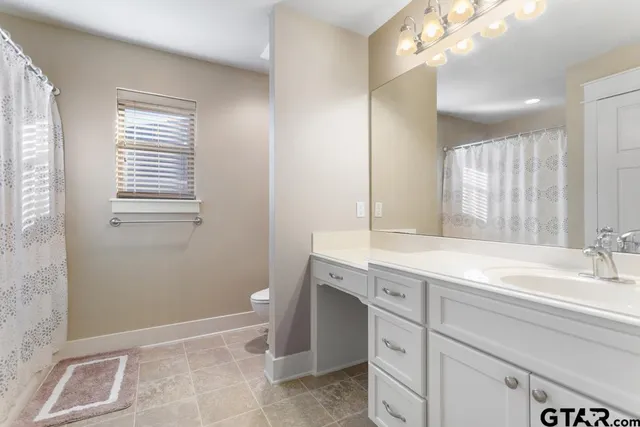 a bathroom with a sink a vanity and a mirror