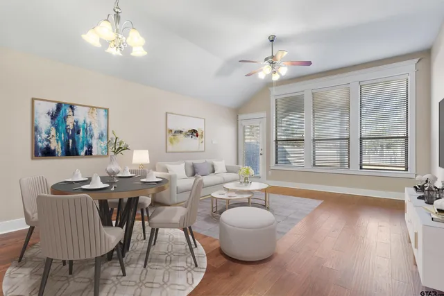 a view of a dining room with furniture wooden floor and chandelier