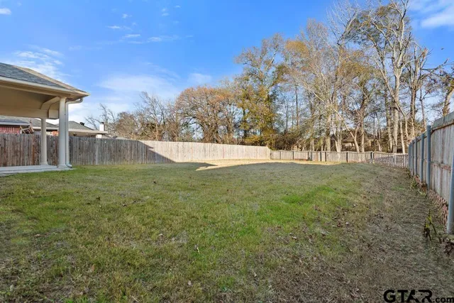 a view of swimming pool with trees and green space