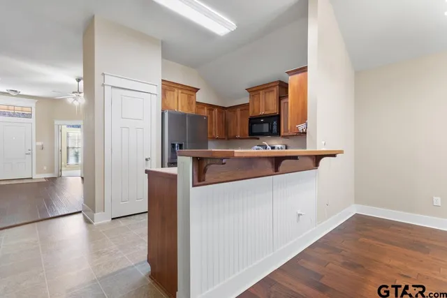 a kitchen with stainless steel appliances a sink and a refrigerator