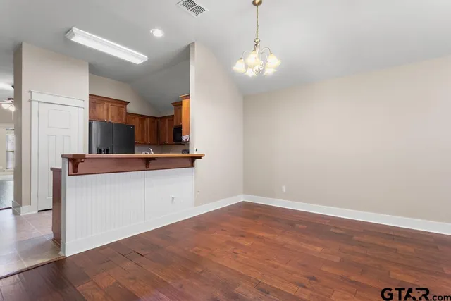 a view of kitchen with granite countertop cabinets and wooden floor