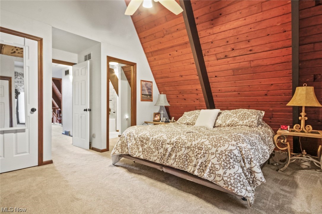 7550 South Raccoon Road Canfield, OH 44406 - Photo 13 of 32 Carpeted bedroom with wood ceiling, ceiling fan, lofted ceiling, and ensuite bath