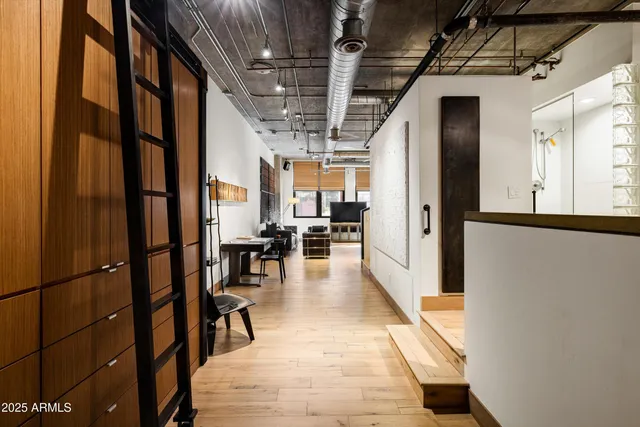 a view of a hallway with entryway dining room and hall with wooden floor