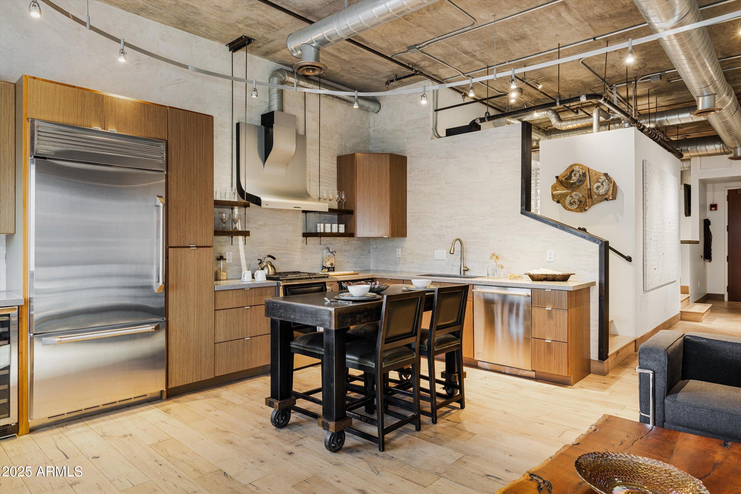 21 East 6th Street, Unit 507 Tempe, AZ 85281 - Photo 16 of 35 a kitchen with stainless steel appliances granite countertop a refrigerator and a stove top oven