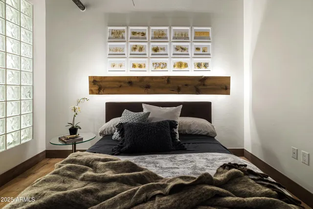 a bedroom with a bed and a large mirror