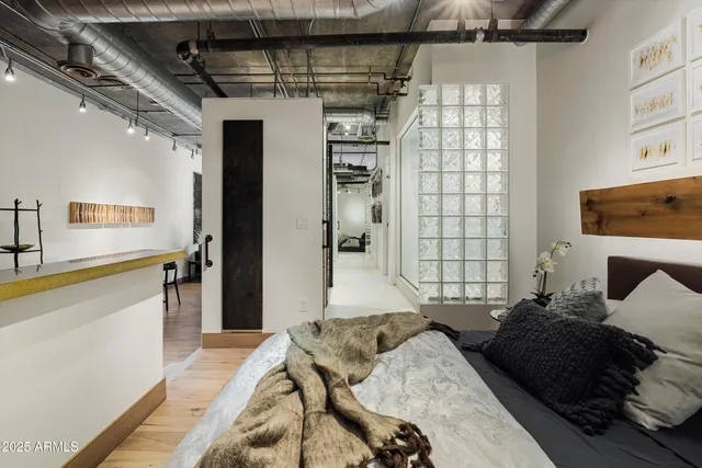 a bedroom with a bed and a television on the wall