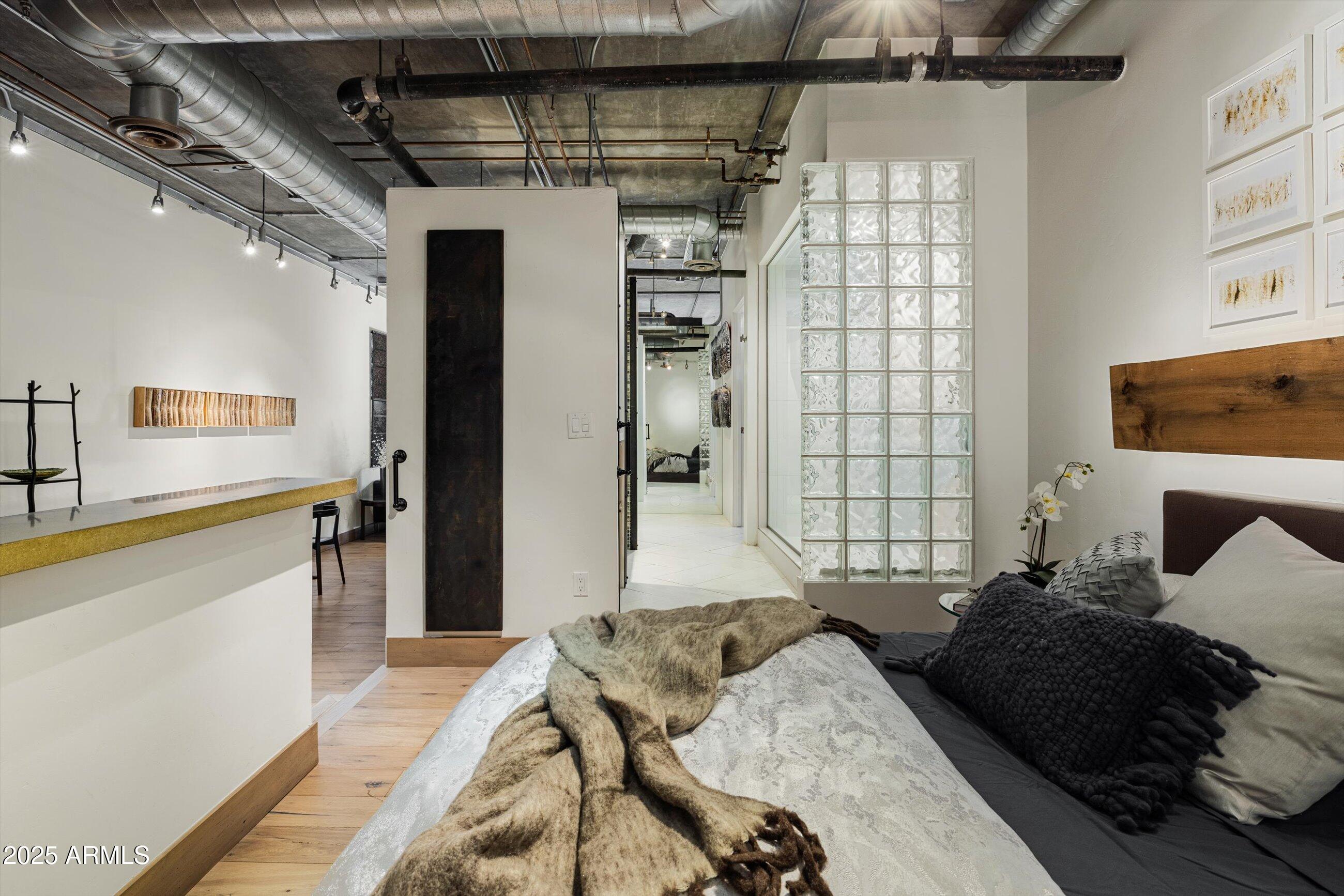 21 East 6th Street, Unit 507 Tempe, AZ 85281 - Photo 6 of 35 a bedroom with a bed and a large mirror