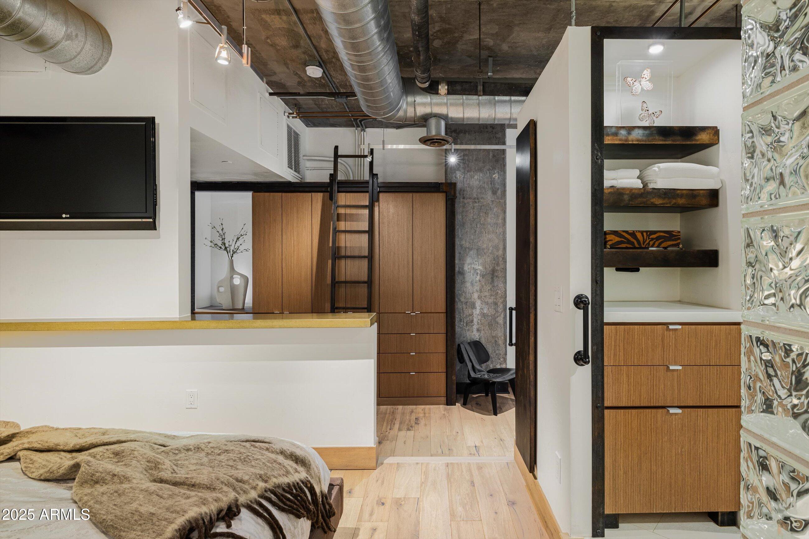 21 East 6th Street, Unit 507 Tempe, AZ 85281 - Photo 7 of 35 a bedroom with a bed and a television on the wall