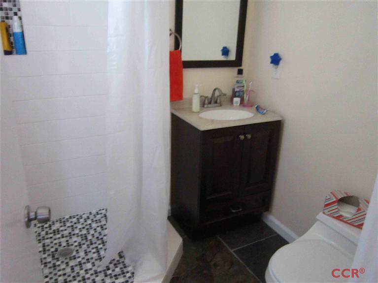 3901 Rigel Avenue Lompoc, CA 93436 - Photo 16 of 17 a bathroom with a sink toilet and vanity