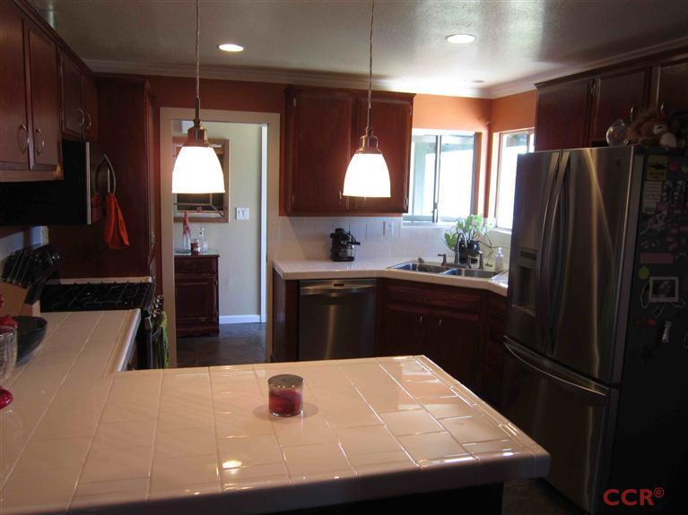 3901 Rigel Avenue Lompoc, CA 93436 - Photo 8 of 17 a kitchen with stainless steel appliances kitchen island granite countertop a refrigerator a sink and dishwasher