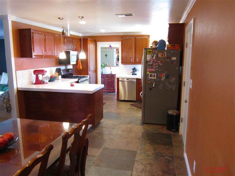 3901 Rigel Avenue Lompoc, CA 93436 - Photo 10 of 17 a kitchen with kitchen island a sink appliances and cabinets