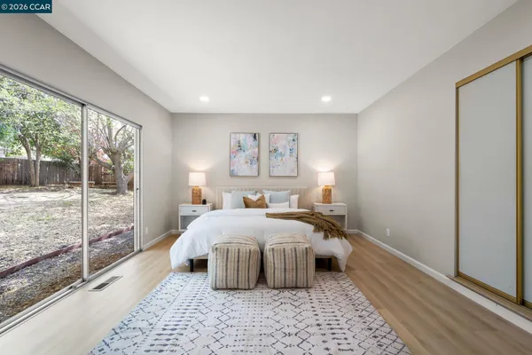a bedroom with a large bed and a large window